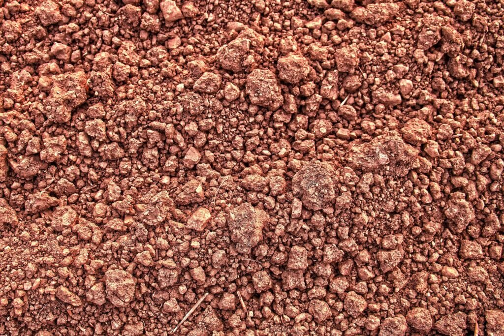 Detailed view of dry, rough soil texture with clay and lumps, perfect for backgrounds.