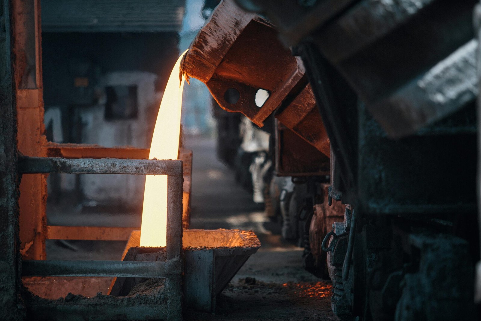 Molten metal pouring in a foundry, showcasing intense industrial processes.